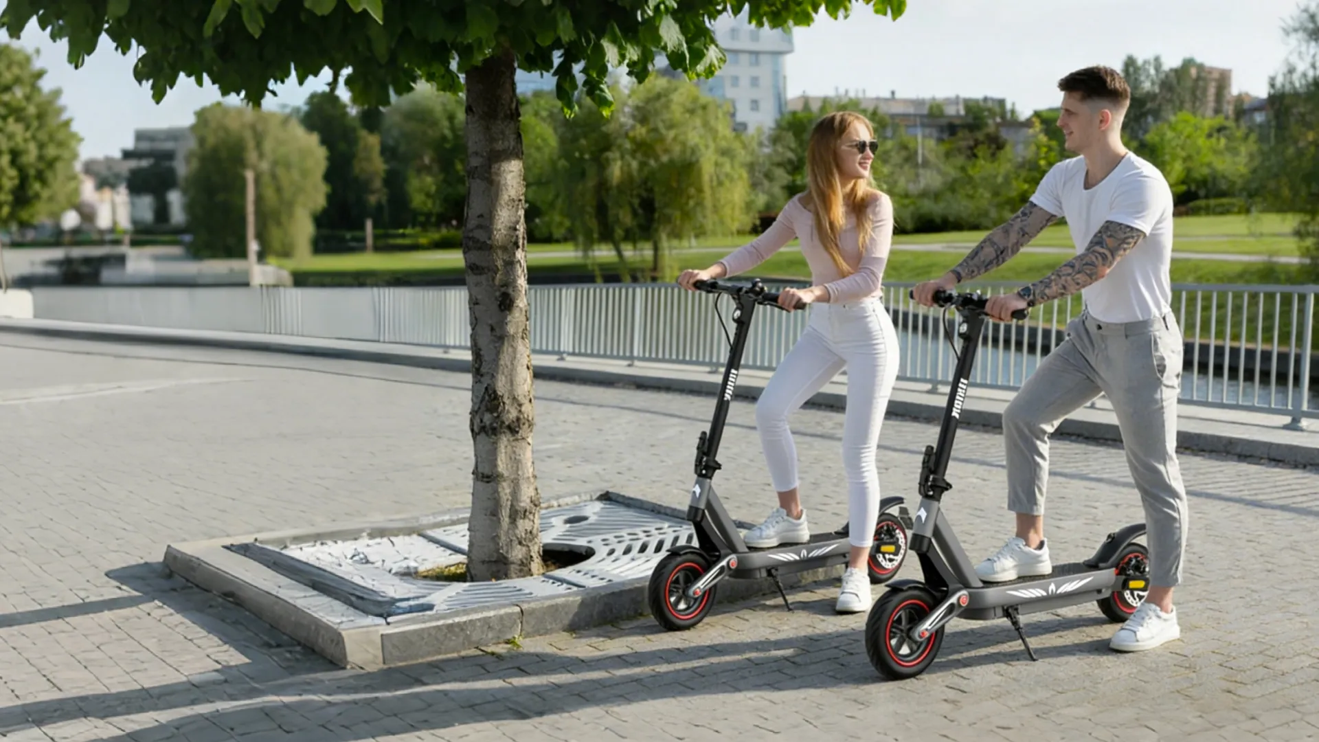 Two riders on Zwheel daily-travel scooters on a city path in the morning