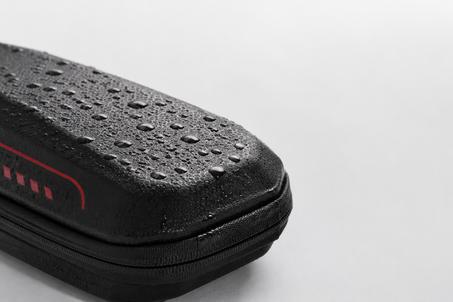 Water droplets beading on the black ZWHEEL scooter bag shell